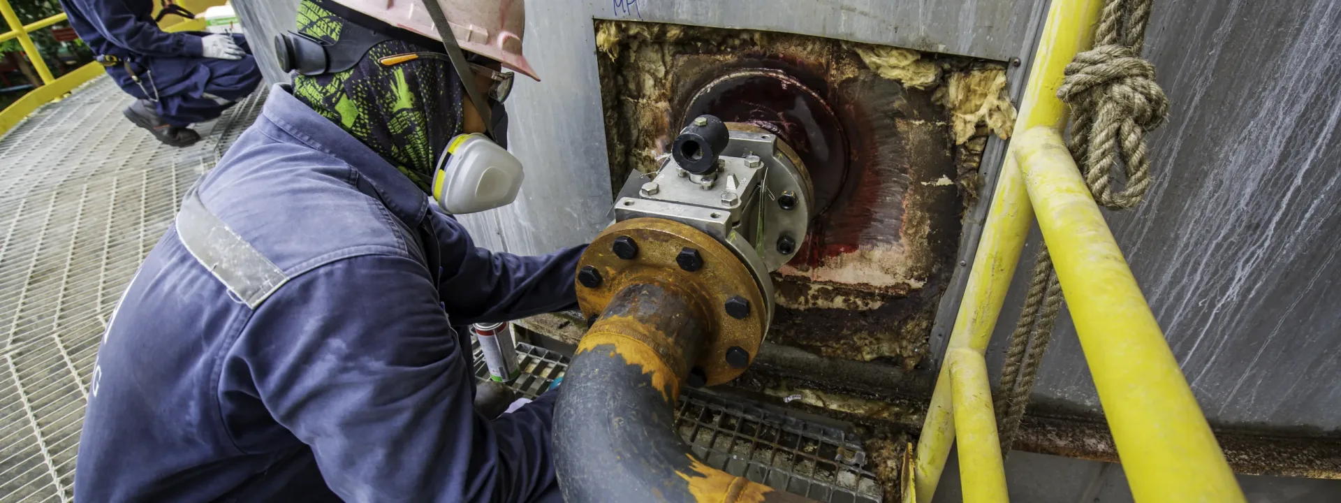 Male worker inspection defect colour red round indication and crack at butt weld equipment nozzle pipeline found by penetrant test.